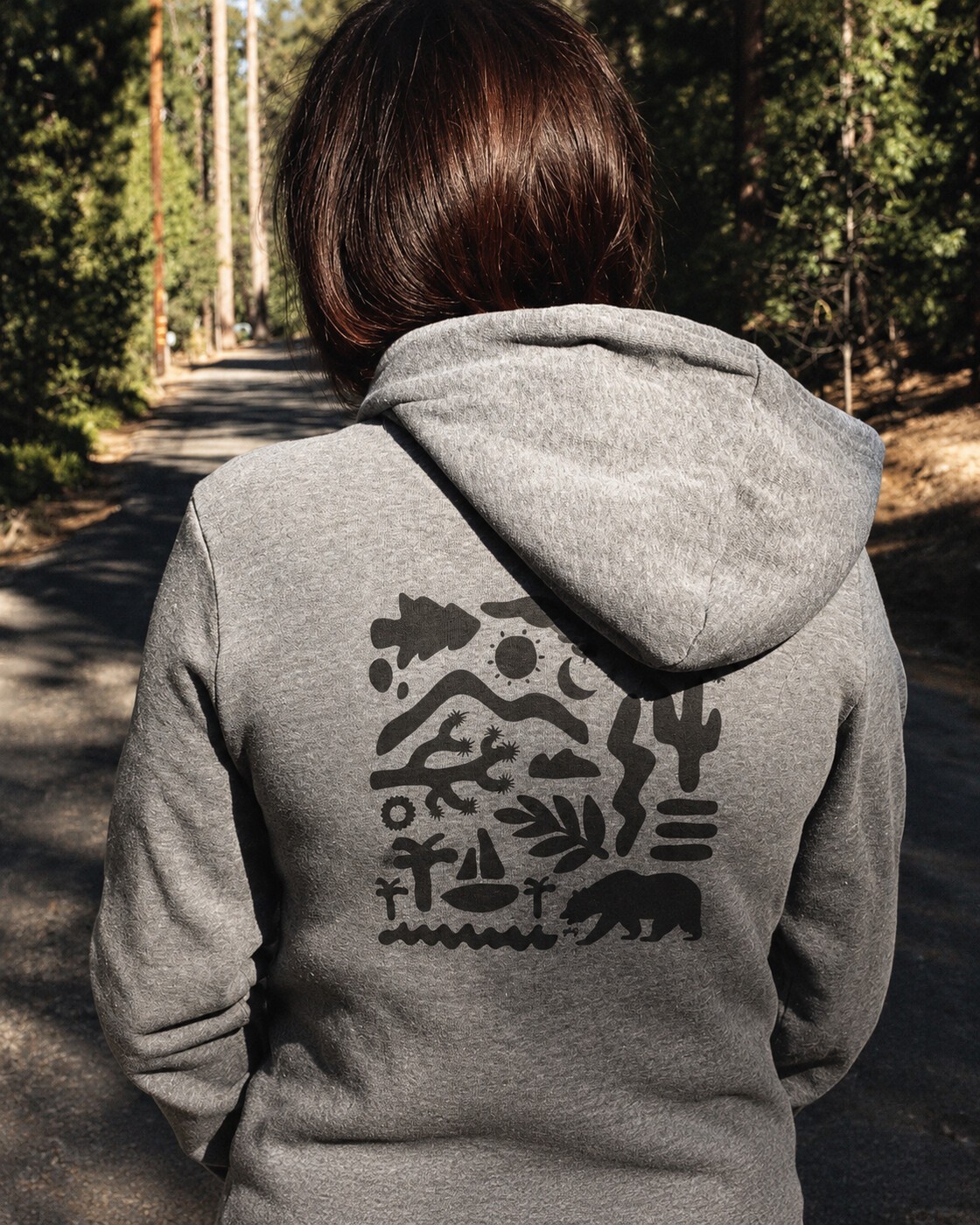 Outdoor graphic hoodie on a woodland trail