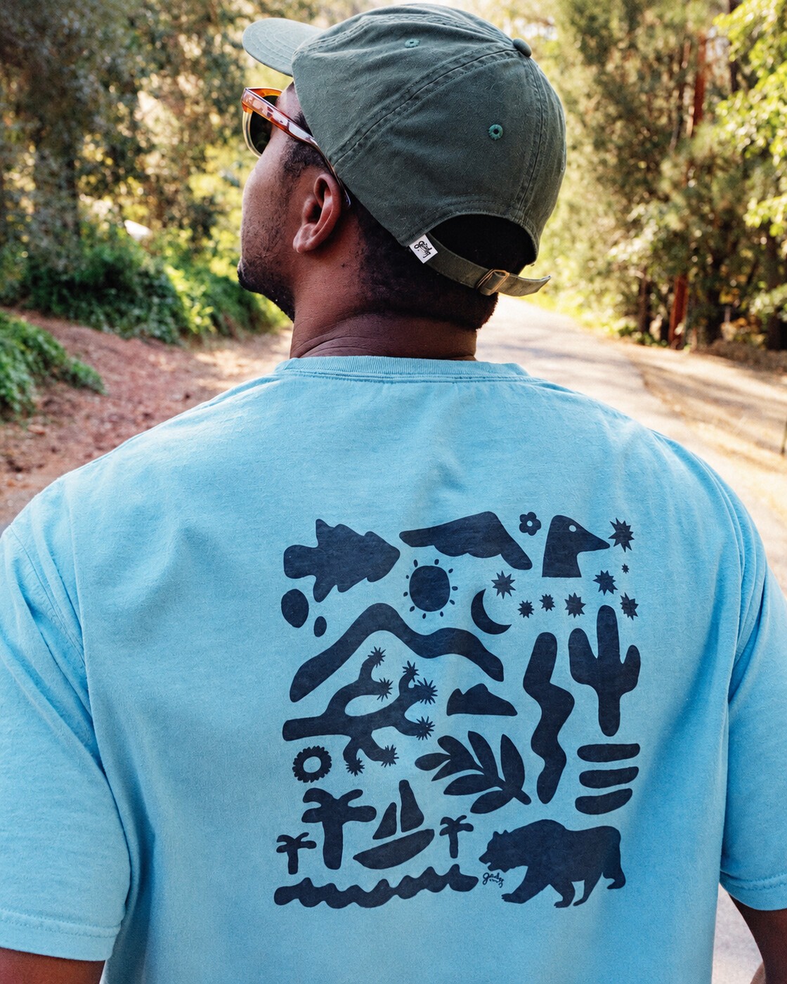 Blue outdoor graphic tee on the trail