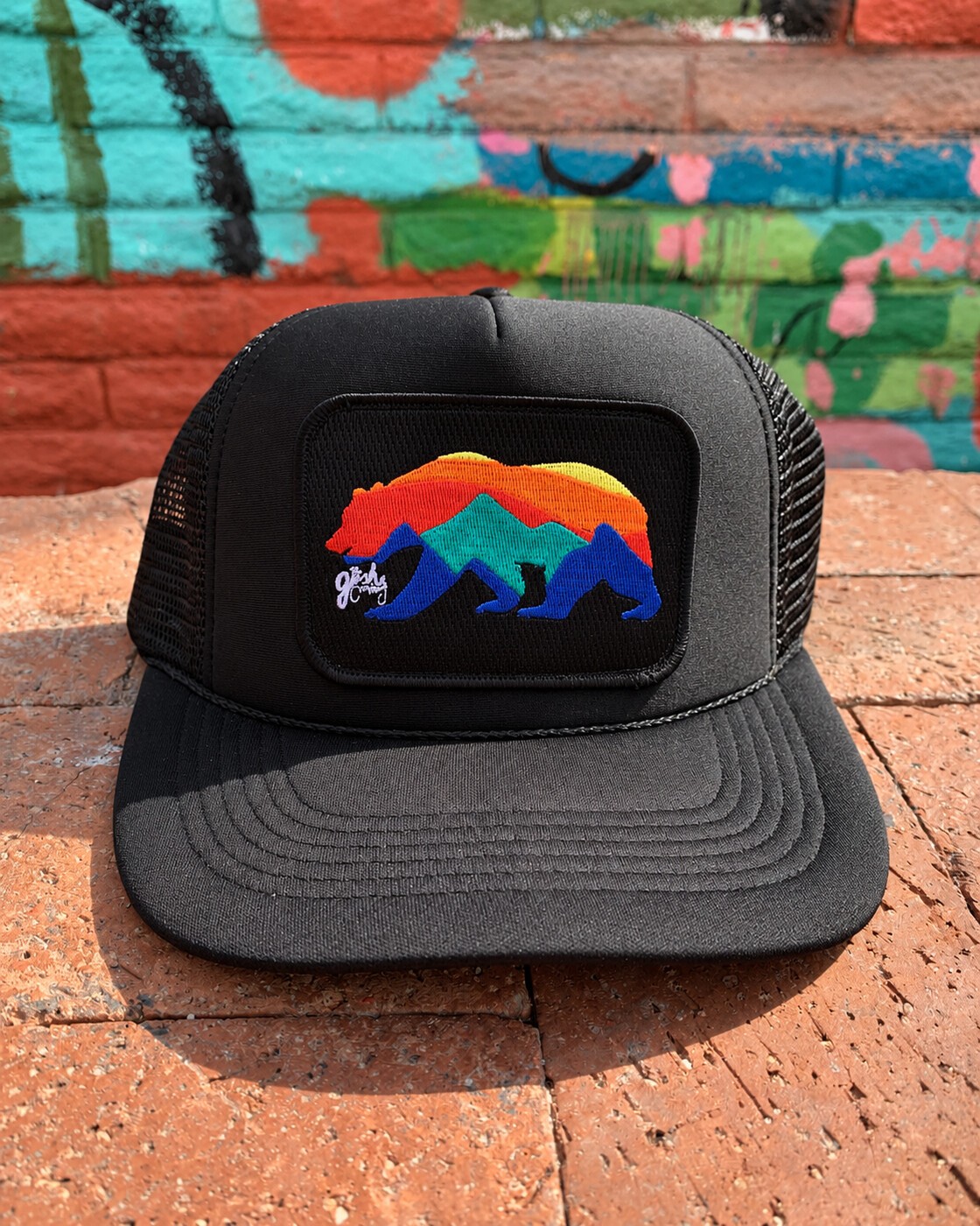 Black bear hat against painted brick