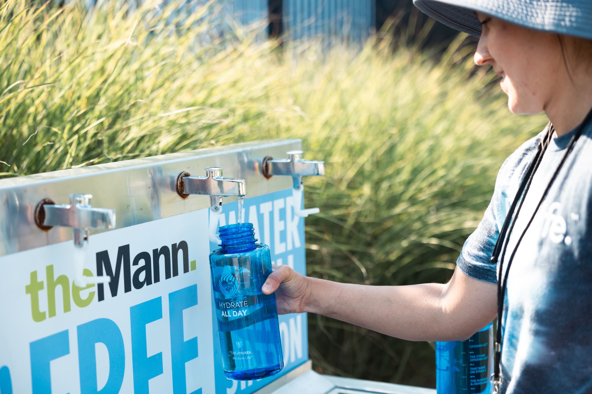 A fan filling a branded bottle at the Hydration Station