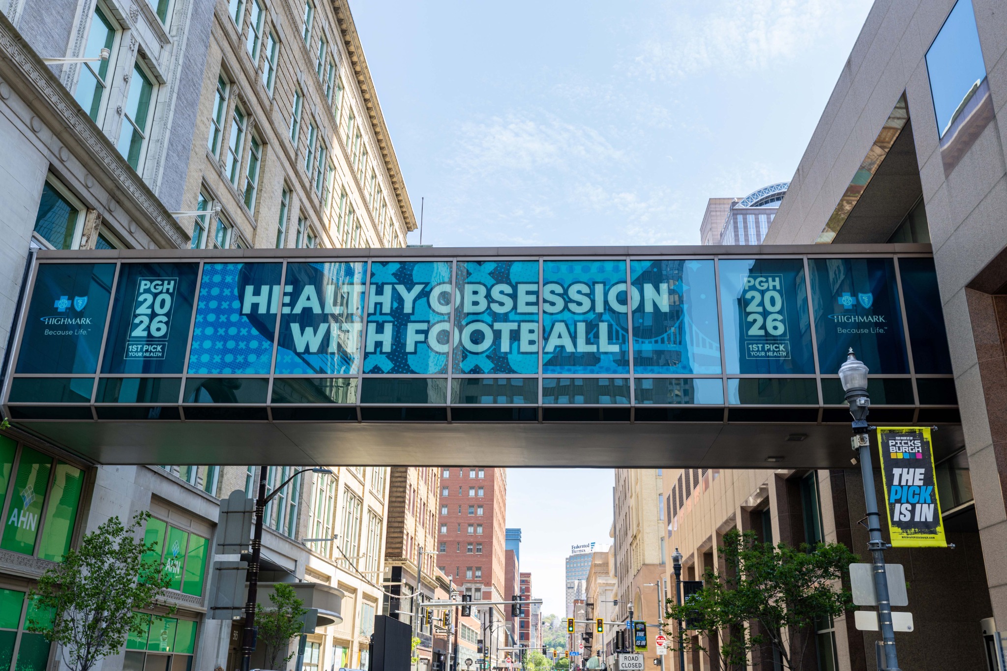Healthy Obsession with Football graphics spanning a Pittsburgh skybridge