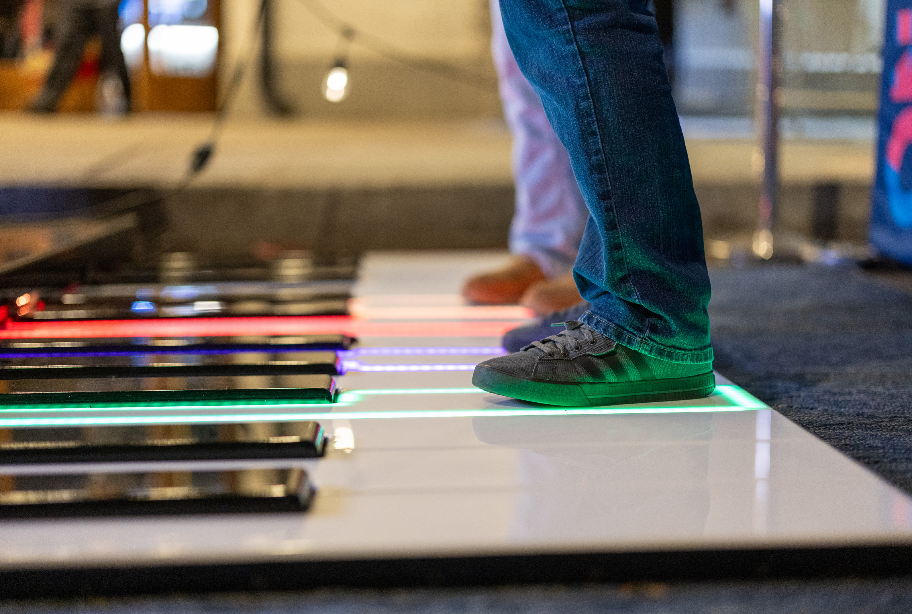 Guest playing the giant illuminated floor piano