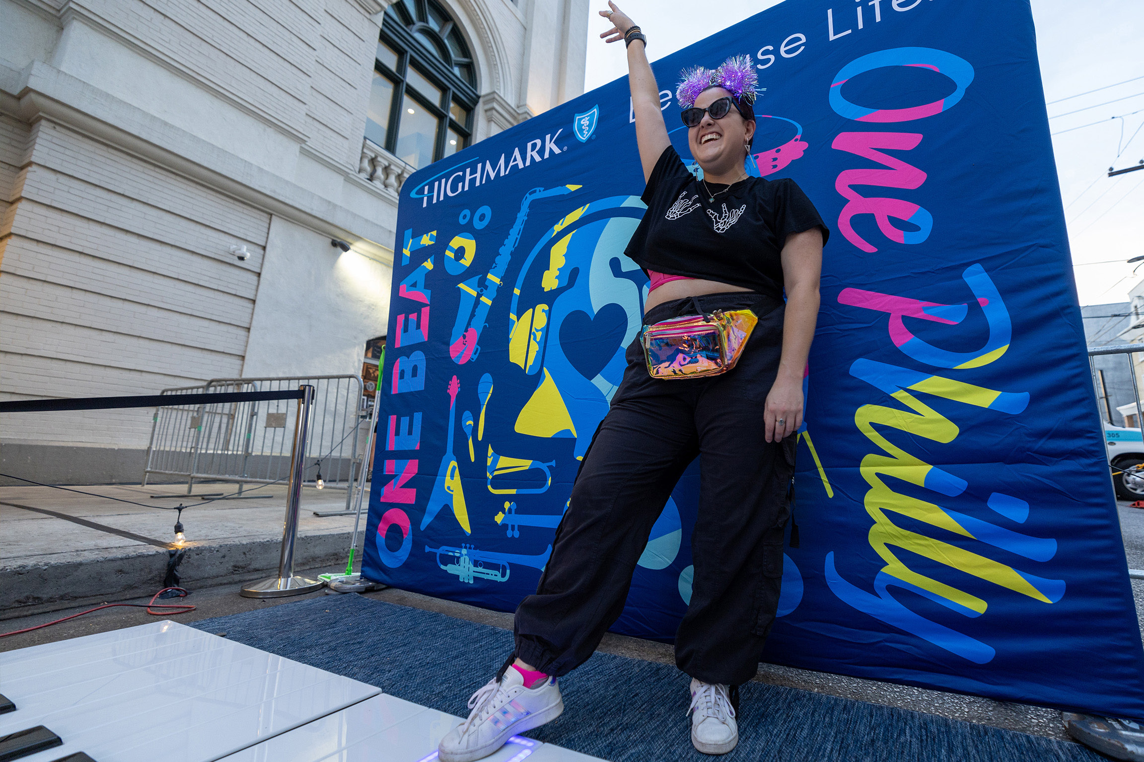 Guest posing at a One Beat One Philly photo installation