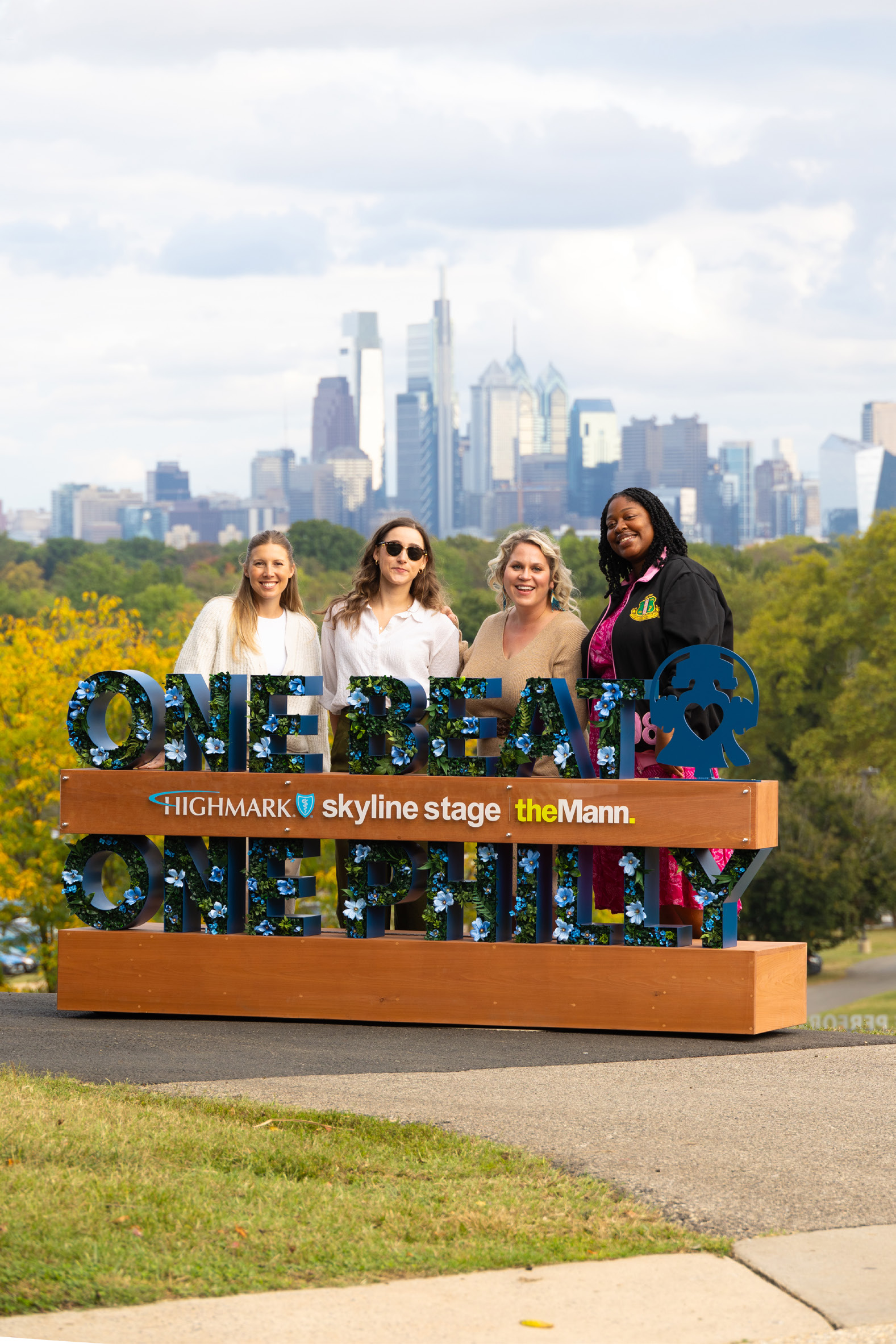 Guests at the One Beat One Philly skyline sign